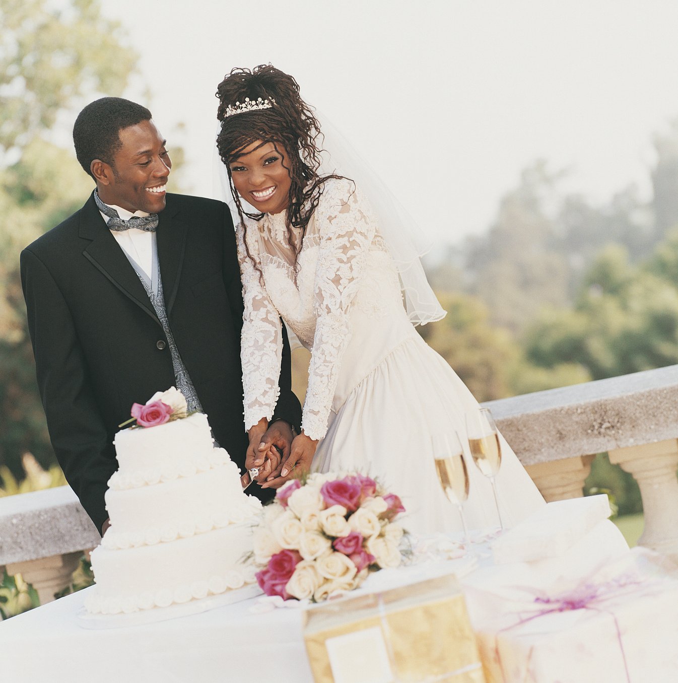 Young Newlywed Couple Cutting the Wedding Cake at their Wedding Reception